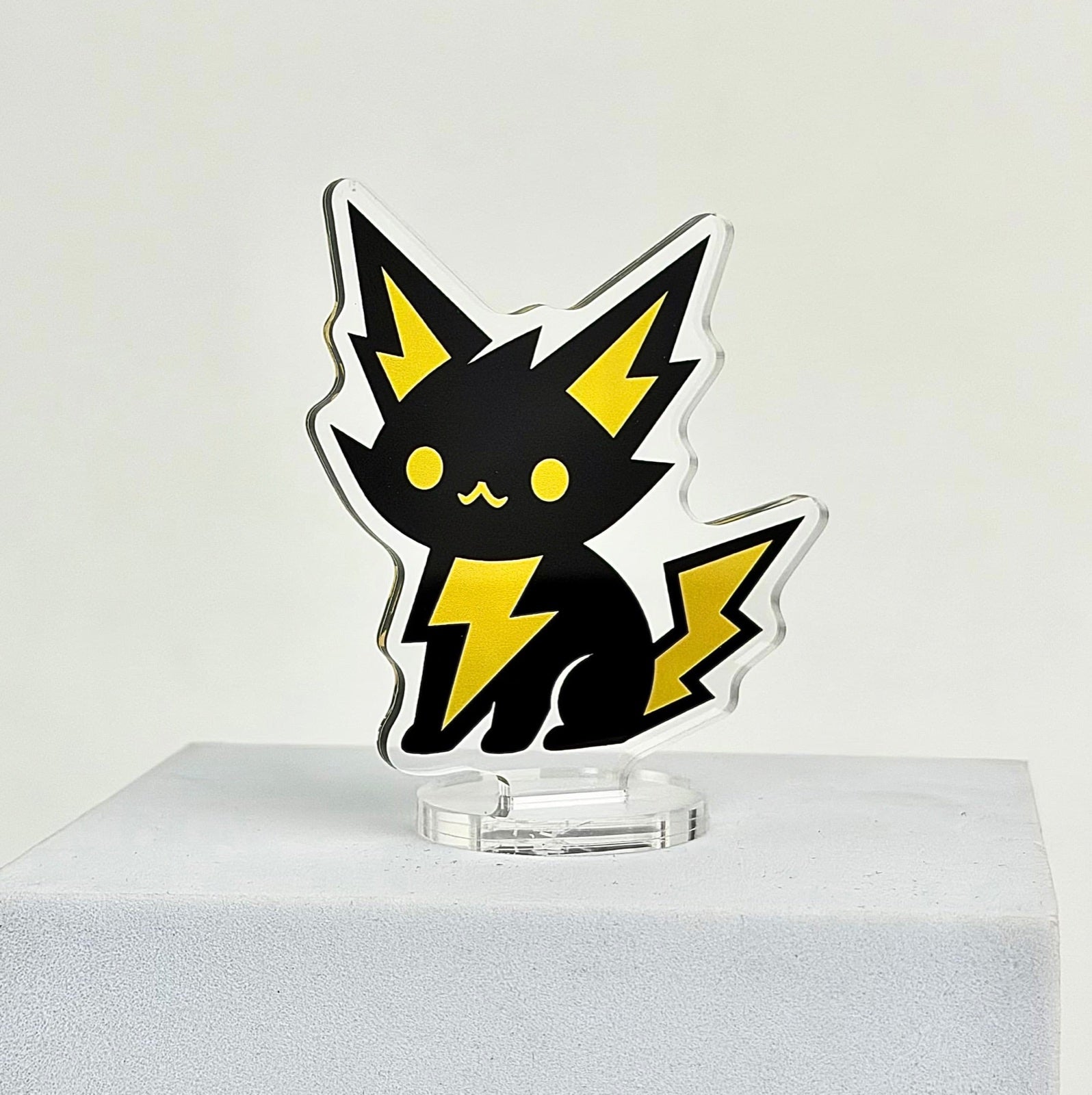 Black and yellow character custom acrylic standee with a clear base